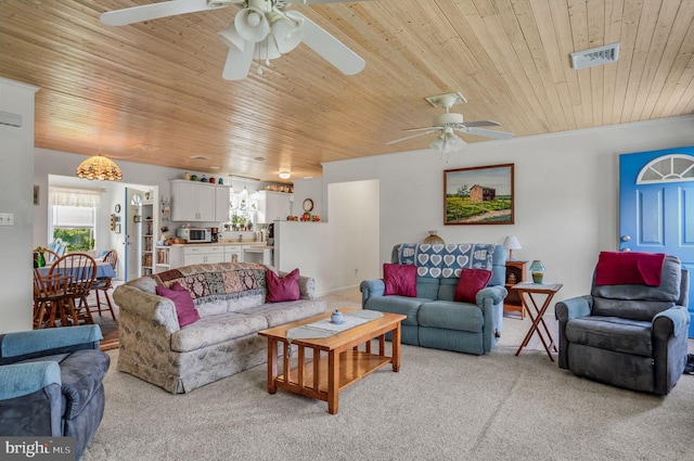 7466 Beebe Rd, Chincoteague Island, VA 23336 - living room featuring a ceiling fan, wood ceiling, and light colored carpet