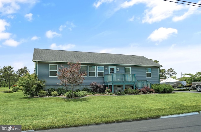 7466 Beebe Rd, Chincoteague Island, VA 23336 - ranch-style home featuring a deck, a front yard, and roof with shingles