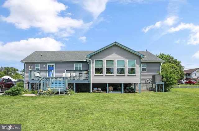 7466 Beebe Rd, Chincoteague Island, VA 23336 - back of house with a wooden deck, a yard, and a shingled roof
