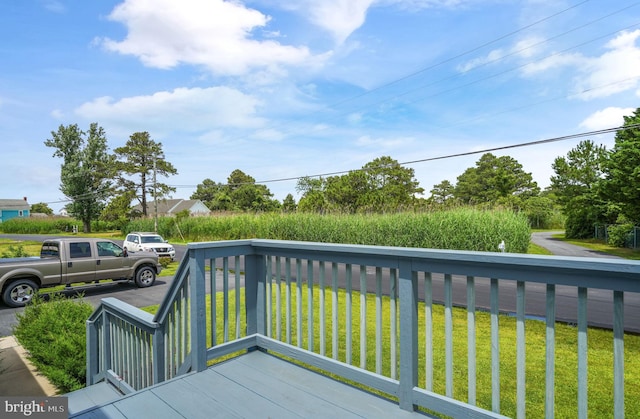 7466 Beebe Rd, Chincoteague Island, VA 23336 - wooden terrace featuring a lawn
