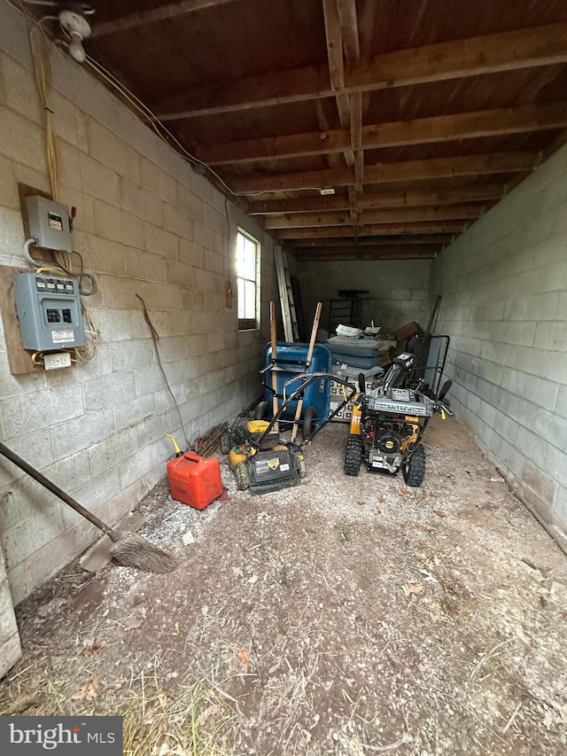 misc room with concrete block wall