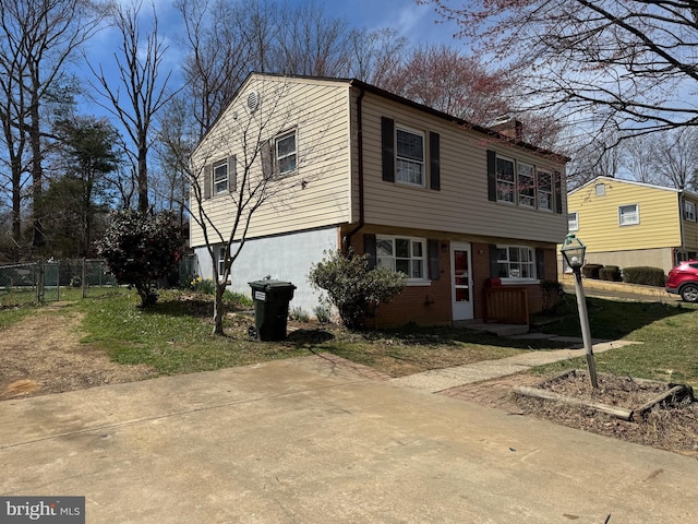 view of front of house with a chimney and brick siding