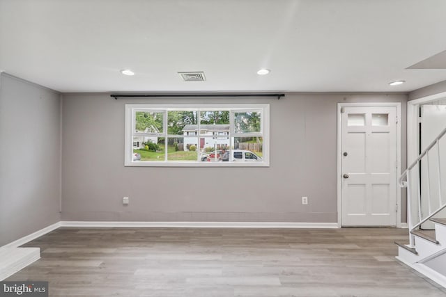 entryway with stairs, light wood-style floors, baseboards, and recessed lighting