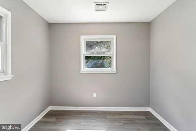 spare room with wood finished floors and baseboards