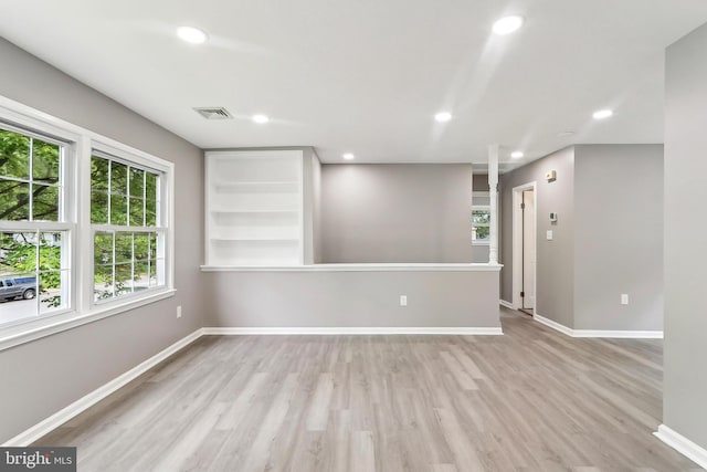 empty room featuring wood finished floors, recessed lighting, and baseboards
