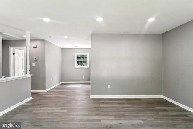 spare room with wood finished floors, baseboards, and recessed lighting