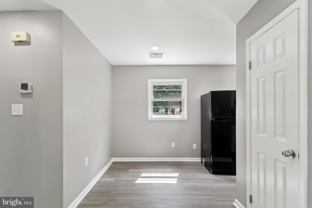 empty room with wood finished floors and baseboards