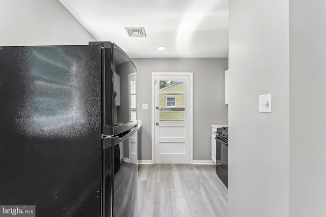 kitchen with black appliances, light wood finished floors, baseboards, and recessed lighting