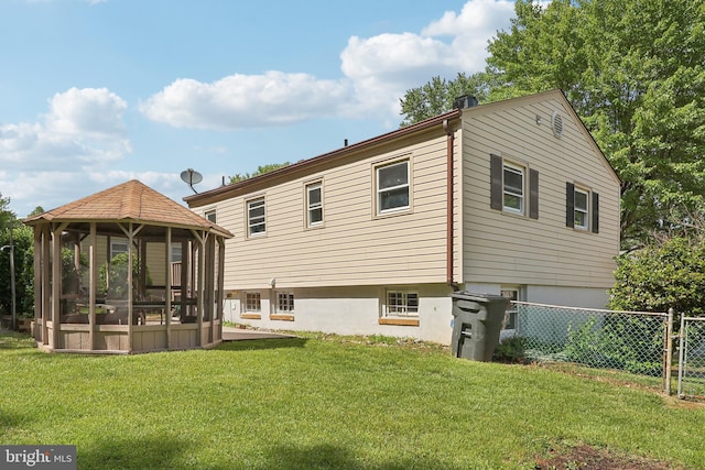 back of house with a gazebo and a sunroom