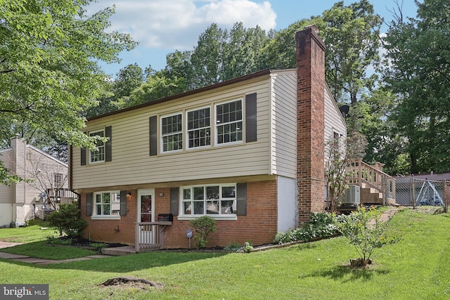 view of front of home featuring brick siding, a front lawn, and a chimney