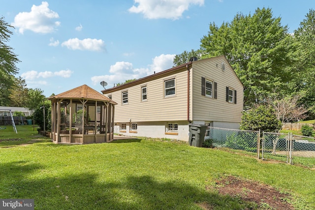 rear view of house with a gazebo and a gate