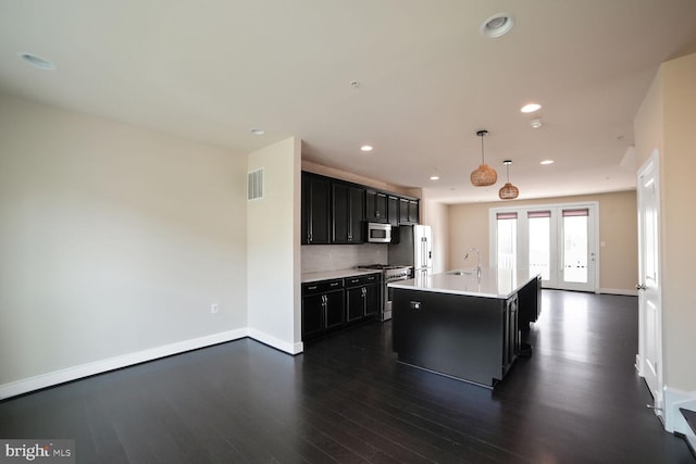 2519 Auden Dr, Silver Spring, MD 20906 - kitchen with appliances with stainless steel finishes, dark cabinetry, dark wood-style floors, light countertops, and recessed lighting