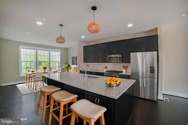2519 Auden Dr, Silver Spring, MD 20906 - kitchen with appliances with stainless steel finishes, dark cabinetry, light countertops, decorative backsplash, and a kitchen breakfast bar