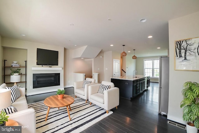 2519 Auden Dr, Silver Spring, MD 20906 - living room featuring dark wood finished floors, a glass covered fireplace, and recessed lighting