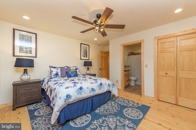 bedroom with wood finished floors, ensuite bath, recessed lighting, baseboards, and ceiling fan