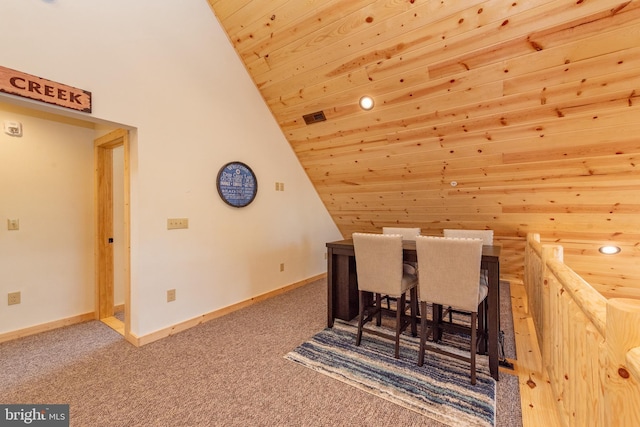dining space featuring vaulted ceiling, wooden ceiling, carpet flooring, and baseboards