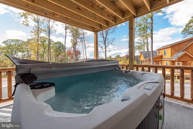 view of swimming pool featuring a hot tub