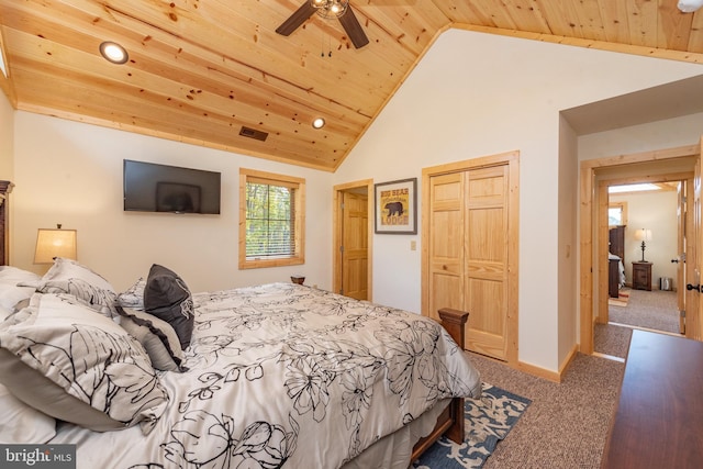 bedroom featuring carpet flooring, wooden ceiling, a closet, and high vaulted ceiling