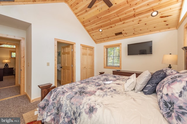 bedroom with carpet flooring, wood ceiling, a closet, and high vaulted ceiling