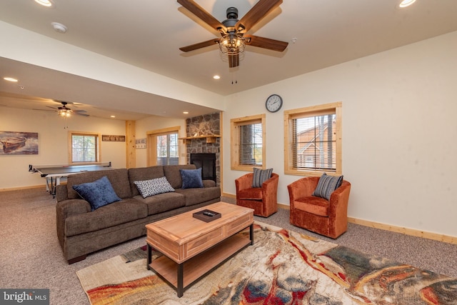carpeted living room with ceiling fan, recessed lighting, a fireplace, baseboards, and plenty of natural light