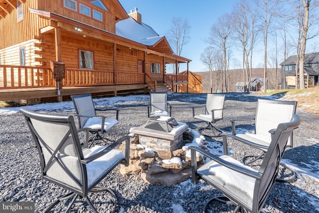 view of patio featuring an outdoor fire pit and a deck
