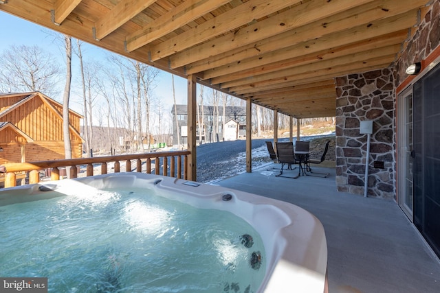 view of pool featuring a hot tub and a patio area