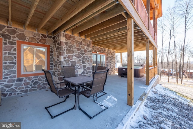 view of patio / terrace with a hot tub and outdoor dining space