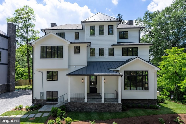 5024 Dana Pl NW, Washington, DC 20016 - view of front of home with a standing seam roof, a porch, a chimney, metal roof, and fence
