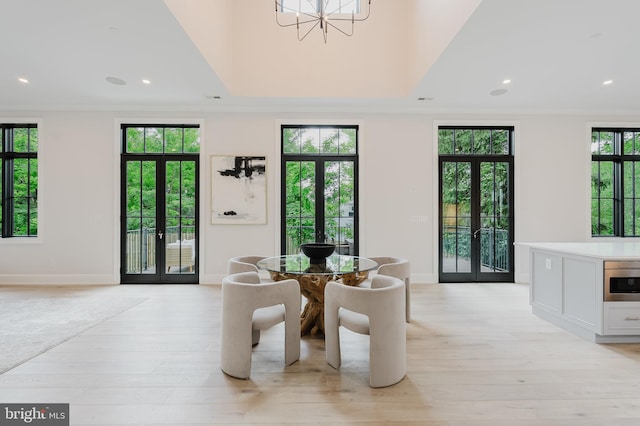 5024 Dana Pl NW, Washington, DC 20016 - dining space with french doors, light wood finished floors, baseboards, a chandelier, and recessed lighting