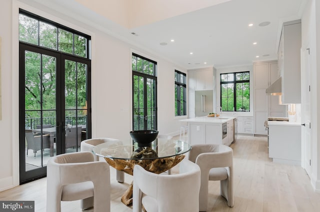 5024 Dana Pl NW, Washington, DC 20016 - dining area featuring plenty of natural light, light wood-type flooring, french doors, crown molding, and recessed lighting