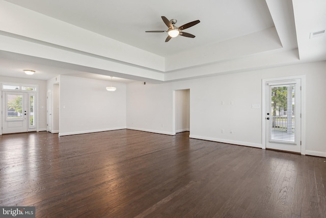 32157 Shorebreak Xing, Millville, DE 19967 - unfurnished living room featuring healthy amount of natural light, a ceiling fan, a raised ceiling, and dark wood finished floors