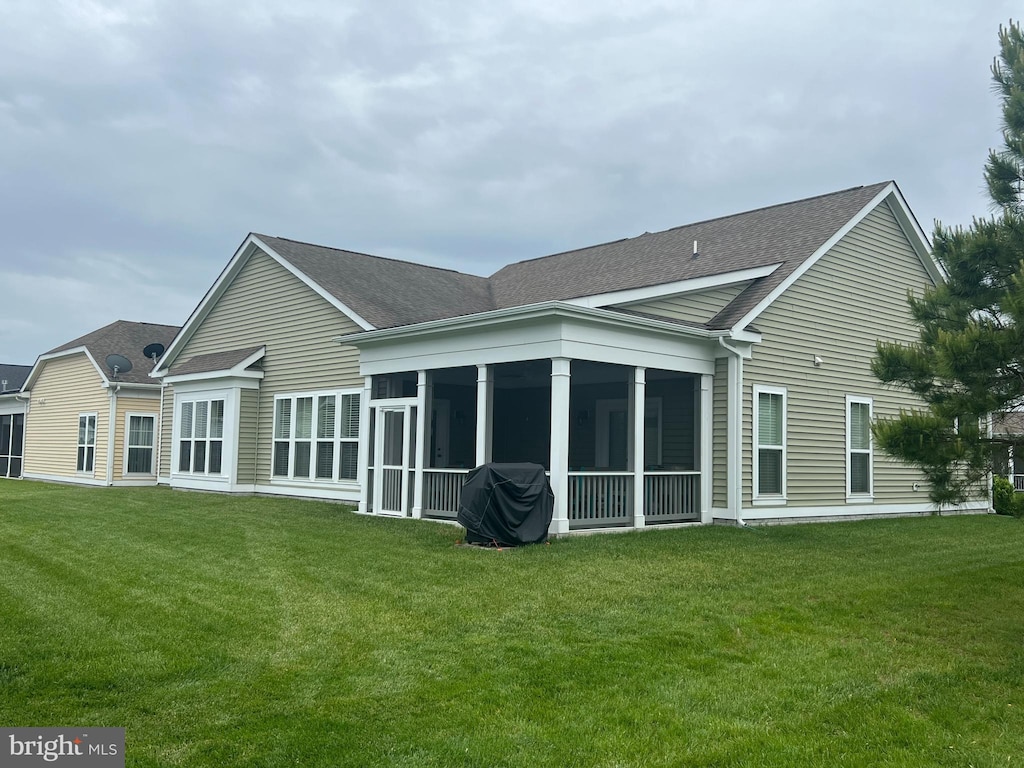 32157 Shorebreak Xing, Millville, DE 19967 - back of house with roof with shingles, a sunroom, and a yard