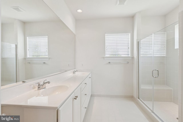 32157 Shorebreak Xing, Millville, DE 19967 - full bath featuring healthy amount of natural light, double vanity, a stall shower, and tile patterned flooring