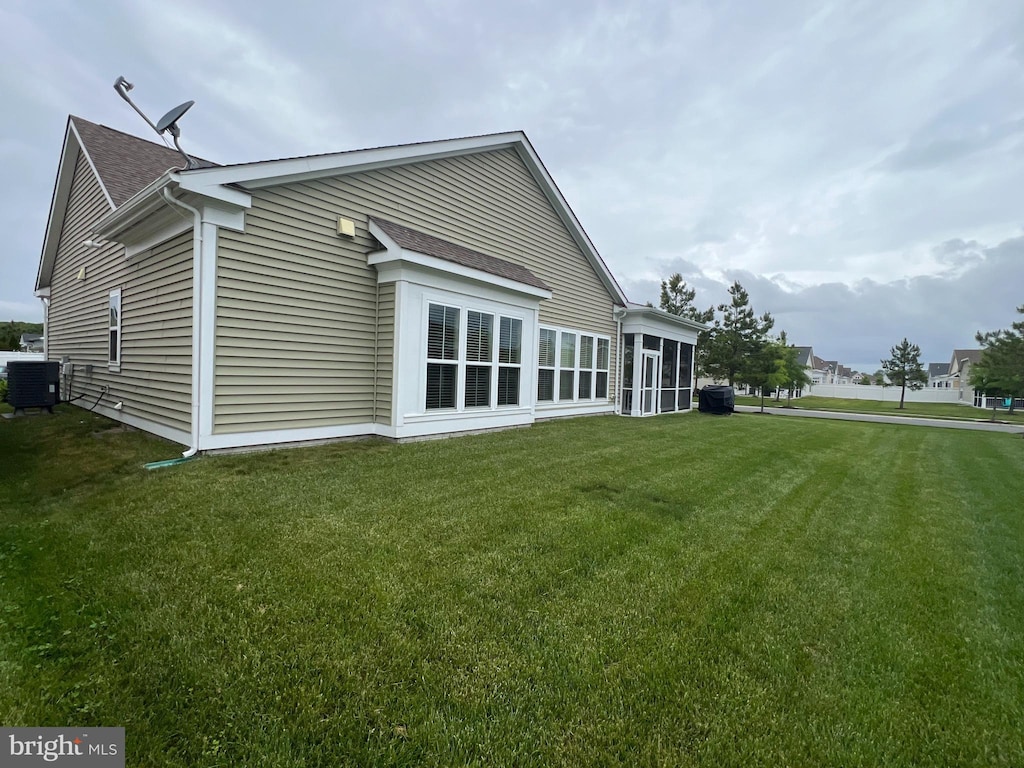 32157 Shorebreak Xing, Millville, DE 19967 - rear view of house with cooling unit, a lawn, and roof with shingles