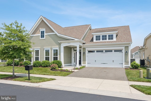 32157 Shorebreak Xing, Millville, DE 19967 - view of front facade with central AC unit, asphalt driveway, a shingled roof, and a front yard