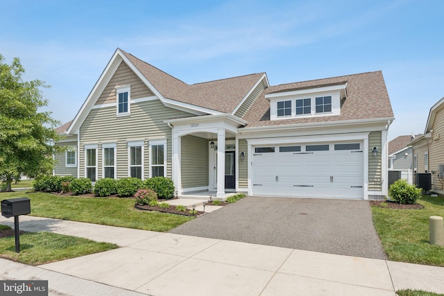 32157 Shorebreak Xing, Millville, DE 19967 - view of front of home with cooling unit, asphalt driveway, a front yard, and roof with shingles