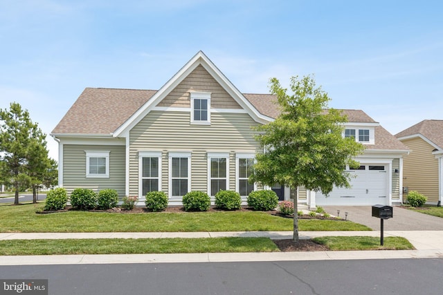 32157 Shorebreak Xing, Millville, DE 19967 - view of front of house featuring a front yard, roof with shingles, a garage, and driveway