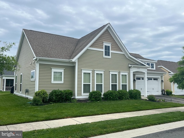 32157 Shorebreak Xing, Millville, DE 19967 - view of front of house featuring an attached garage, a shingled roof, a front lawn, and asphalt driveway