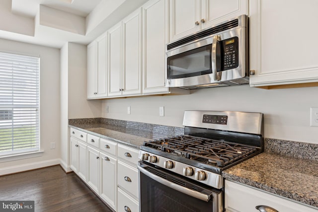 32157 Shorebreak Xing, Millville, DE 19967 - kitchen with stainless steel appliances, dark wood-style floors, white cabinetry, and dark stone counters
