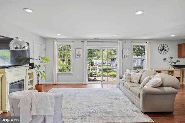 600 Trenton Rd, Langhorne, PA 19047 - living room with recessed lighting, dark wood-style flooring, a glass covered fireplace, and baseboards