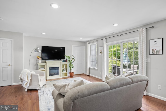 600 Trenton Rd, Langhorne, PA 19047 - living area with baseboards, wood finished floors, a glass covered fireplace, and recessed lighting