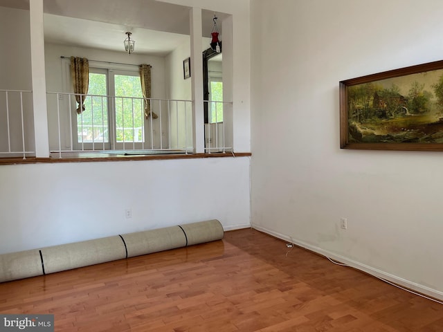 empty room featuring wood finished floors and baseboards
