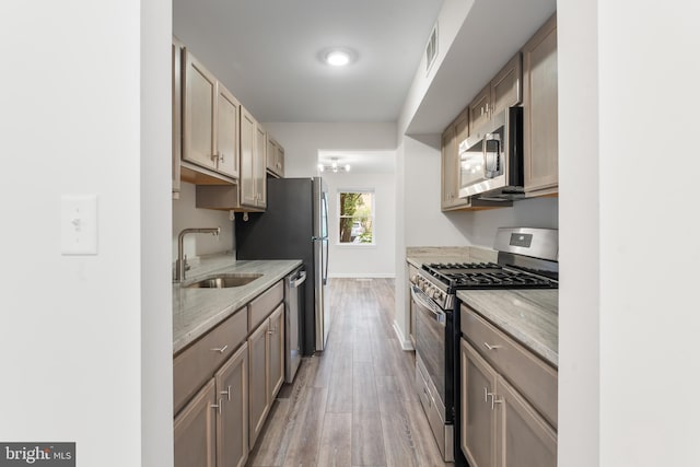 662 W Side Dr Unit 1-H, Gaithersburg, MD 20878 - kitchen with appliances with stainless steel finishes, a sink, light wood-style floors, baseboards, and light stone counters