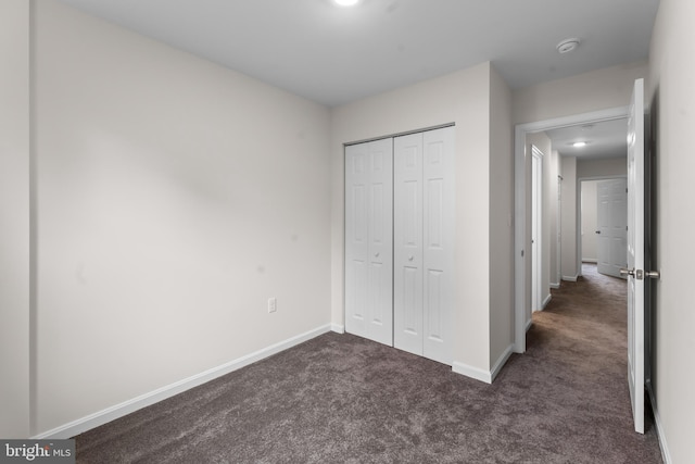 662 W Side Dr Unit 1-H, Gaithersburg, MD 20878 - unfurnished bedroom with dark carpet, baseboards, and a closet