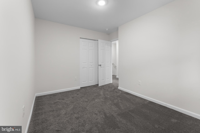 662 W Side Dr Unit 1-H, Gaithersburg, MD 20878 - unfurnished bedroom featuring baseboards, dark colored carpet, and a closet