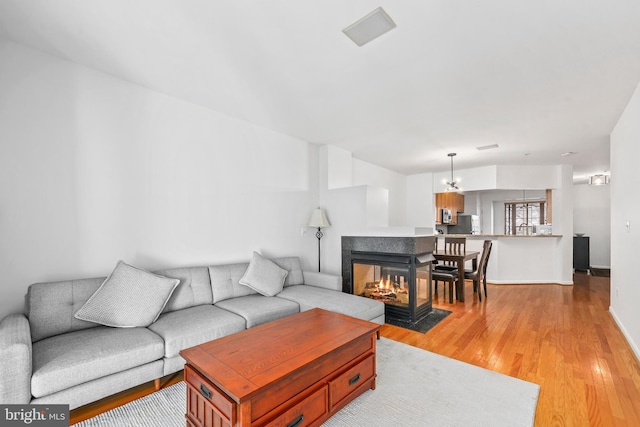 1510 Northern Neck Dr Unit 102, Vienna, VA 22182 - living area with light wood-type flooring, baseboards, and a chandelier