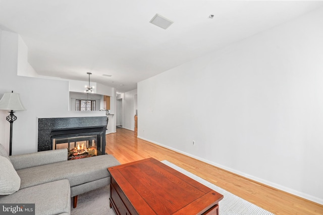 1510 Northern Neck Dr Unit 102, Vienna, VA 22182 - living area with light wood-type flooring, baseboards, and a multi sided fireplace