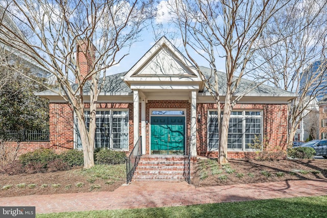 1510 Northern Neck Dr Unit 102, Vienna, VA 22182 - view of front of home featuring brick siding and a chimney