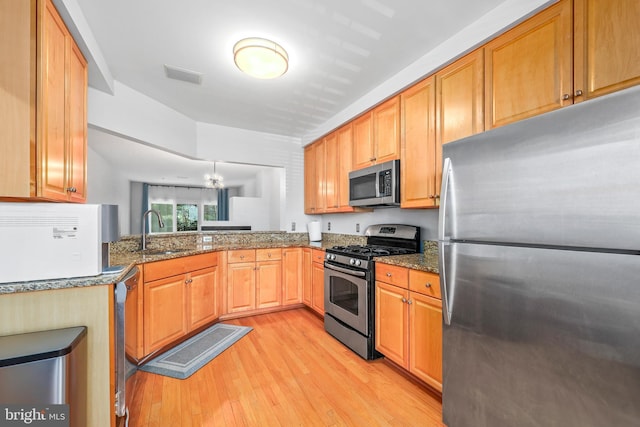 1510 Northern Neck Dr Unit 102, Vienna, VA 22182 - kitchen with stainless steel appliances, a sink, light wood-type flooring, and dark stone countertops