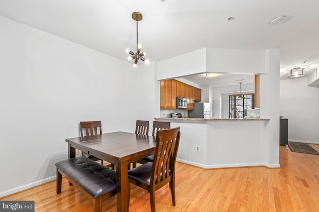 1510 Northern Neck Dr Unit 102, Vienna, VA 22182 - dining room with light wood finished floors, a chandelier, and baseboards